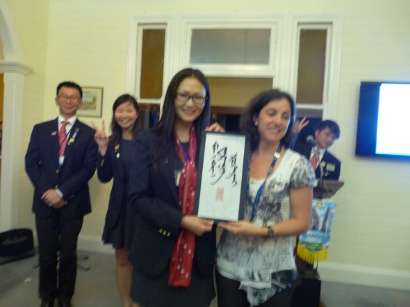 Bolor presenting the beautiful Mongolian Calligraphy to President Simone of RC of Mt Warning AM